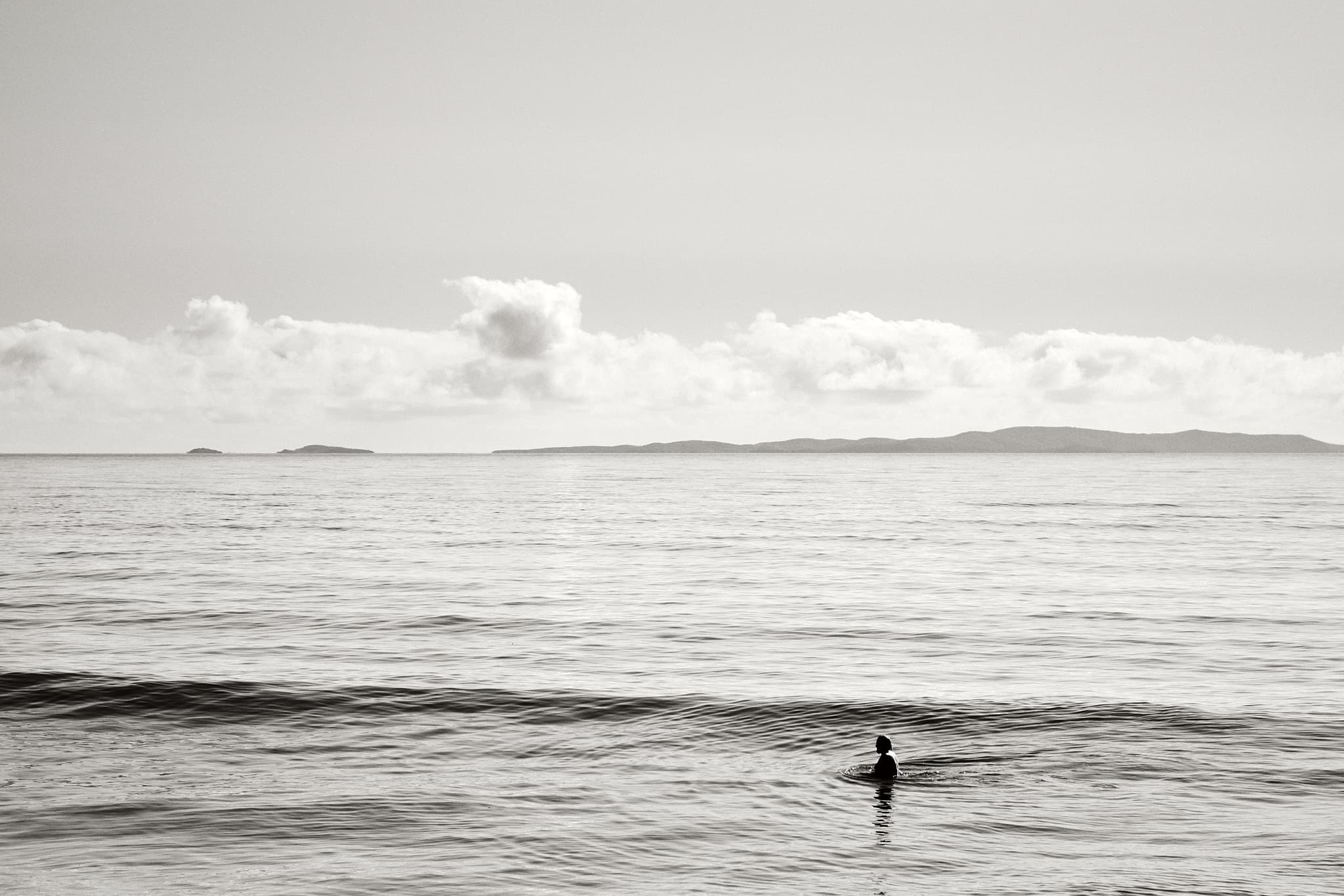 Man swimming alone, Yeppoon Main Beach