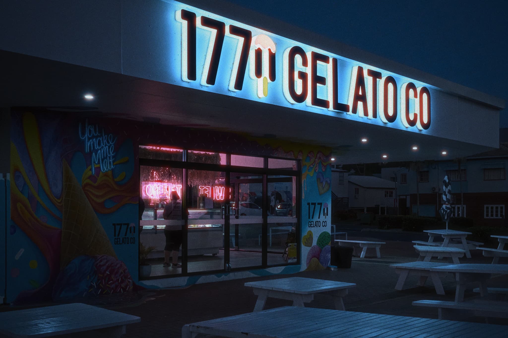 Woman alone in gelato shop at dusk, Yeppoon